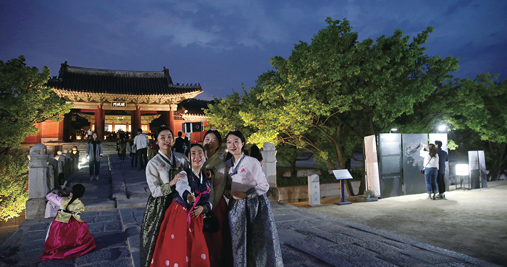 서울 종로구 창경궁에서 젊은 여성들이 화려한 한복을 차려 입고 셀카 촬영을 즐기고 있다. 많은 경우에 전통문화의 가치를 되새기는 것보다는 특별한 인증샷을 찍기 위한 목적으로 보인다. Tại cung Changgyeong ở Seoul, các cô gái trẻ trong bộ váy truyền thống hanbok đang tự chụp ảnh bằng gậy selfie. Họ có vẻ thích thú với “những tấm ảnh bằng chứng” hơn là di tích lịch sử phía sau. ⓒ조선일보사