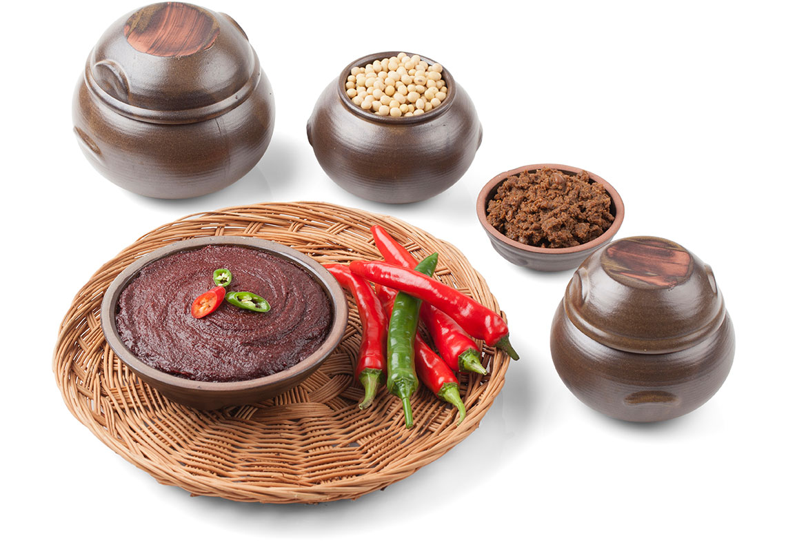 In the center is gochujang made from red chilies. At the 12 oclock position are soybeans which are used to make doenjang